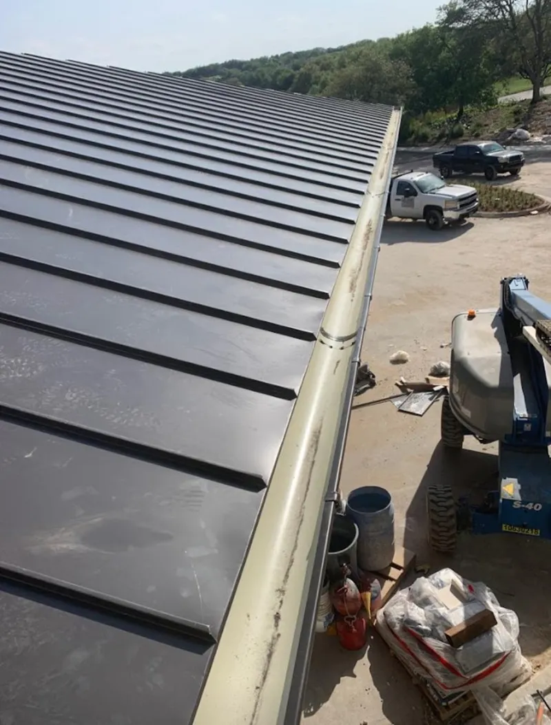 Standing seam panel and gutter detail on a metal roofing jobsite in Rodeo